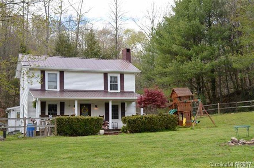 Charming 2-story farmhouse combines original character of early 20th century construction w/modern conveniences. Main lvl features include living room w/FP, den, full BA w/updated vanity & tile work, sitting room w/window seat & wood stove (provides supplemental heat to entire house), dining room w/back patio access & kit w/tile flooring, updated cabinetry & fixtures. Main lvl laundry room w/direct exterior access. 2nd lvl offers 4 BRs w/lrg windows & 2nd full BA w/jetted tub & updated vanity.