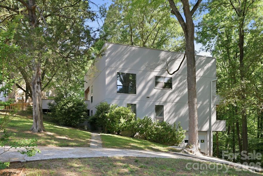 Nestled on a private, tree-lined one-acre lot in Mountainbrook, one of SouthPark/South Charlotte’s most established and sought-after neighborhoods, 3423 Tinkerbell Lane offers a rare blend of privacy, character, and convenience.

Built in 1977 with bold contemporary architecture, this distinctive home feels like a peaceful treehouse retreat surrounded by mature trees. The setting offers a true sense of escape, while still being just minutes from SouthPark’s shopping, dining, everyday conveniences, and many of Charlotte’s top public and private schools.

With approximately 2,900 square feet and 4 bedrooms, the home features a unique tiered layout designed to capture natural light and wooded views. The main living areas are positioned on the upper level, creating an inviting space for gathering, entertaining, and enjoying the serene surroundings. Architectural details such as wide banisters, angled walls, multiple balconies, and generous windows add warmth, interest, and personality throughout the home.

The large gathering room with a standalone fireplace provides a comfortable space for entertaining or relaxing evenings at home, while the cozy den is ideal for movie nights or quiet downtime. The primary suite offers peaceful views through the trees, and the lower level creates the feel of a private retreat with walk-out access to the lower-level deck, affectionately known as “Our Secret Garden.” This secluded outdoor space offers a peaceful escape for quiet reflection, morning coffee, or outdoor entertaining, all surrounded by the natural beauty of the wooded lot. The lower level feature a tandem garage that will hold 2 cars. 

Lovingly maintained for more than three decades, this home offers the opportunity to move in and enjoy its unique character or thoughtfully renovate over time to make it your own. The one-acre wooded lot provides exceptional privacy, mature landscaping, and a beautiful natural setting, while still being part of a vibrant and welcoming community.

Residents of Mountainbrook also have the option to join the Mountainbrook Swim and Tennis Club, offering community amenities without a mandatory HOA. Known for its mature trees, welcoming atmosphere, and strong sense of community, Mountainbrook continues to be one of Charlotte’s most desirable neighborhoods.

3423 Tinkerbell Lane is more than just a home—it is a special opportunity to enjoy space, privacy, and character in an exceptional SouthPark location.