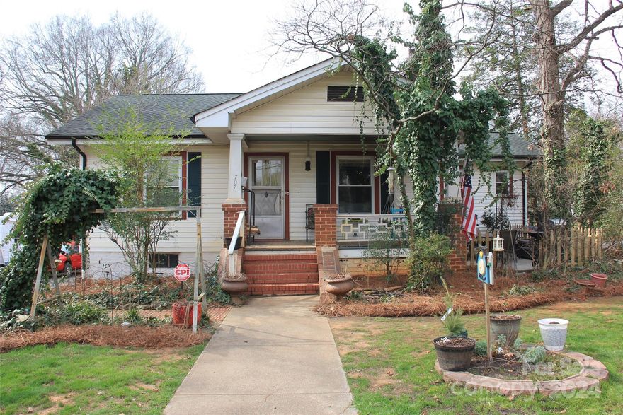 Charming 1926 bungalow convenient to I-40, Downtown Statesville, & all Statesville's amenities! Situated on approximately 1/2 acre corner lot w/circular driveway. 10x18 workshop w/power & water w/18x20 covered carport w/concrete pad. Separate 10x10 storage building. Exterior features of the home include a covered rocking chair front porch, 15x14 concrete side patio, 2nd level wooden deck in the rear, additional covered parking for 2, backyard w/raised gardening beds.  Roof replaced in 2013. Electric heat pump installed in 2021. Interior flooring consists of wood floors & tile, no carpet. Formal dining room opens to living room, both w/chair rail & crown molding. Living room has built in shelves & wood burning fireplace. Kitchen has a walk in pantry, breakfast area, & farmhouse sink w/Moen faucet. The main part of the home has 2 BR's & 1 FB. Accessible from exterior entrance only is a separate (3rd) bedroom & full bath.  Security system in place.  Make this one yours before it's gone!
