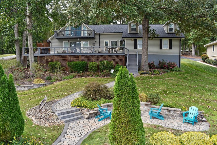 This waterfront home is located off Badin Lake's main channel. Near the mouth of a desirable deep-water cove between Sunrise Point & Dixie Shores. Large .55 acre lot in the peaceful little Sunrise Point area (Lot #1). Recently remodeled home. The main level features a kitchen, living room & dining room with fantastic views. Open kitchen & living area. Granite counter tops. Large lakeview deck & grilling area. Fully shaded deck makes it perfect for families during the hot summers. Cape Cod outdoor shower. Laundry on main. The upper level features 2 bedrooms, a lakefront balcony, game room & office.
Huge stationary pier with covered boat slip & heavy lift, 2 covered jet ski slips & grandfathered upper sundeck. Ideal for swimming & fishing, away from heavy boat traffic. Main channel views. Plenty of shaded area under the pier sundeck for relaxing with the steady breeze that comes through the cove regularly. Seawall that spans the 113 feet of waterfrontage. Fully manicured front lawn with Zoysia grass, stone walkways & large stone walls with lakeside fire pit in front. Stone walls with large planter beds in the rear with fruit trees & Crepe Myrtles throughout. Some furniture negotiable. Pontoon boat negotiable-ask listing office for details. County water & sewer. Circular asphalt driveway; plenty of parking. Paved, public Whip O Will Wildlife boat landing within the neighborhood. Convenient to the lake’s marinas that provide dining, gas & watercraft rentals. The Uwharrie National Forest 5 minutes away is a great destination for camping, hiking, horseback riding & ATV/OHV trails. Within 1 hour from Charlotte, Greensboro or Winston-Salem.