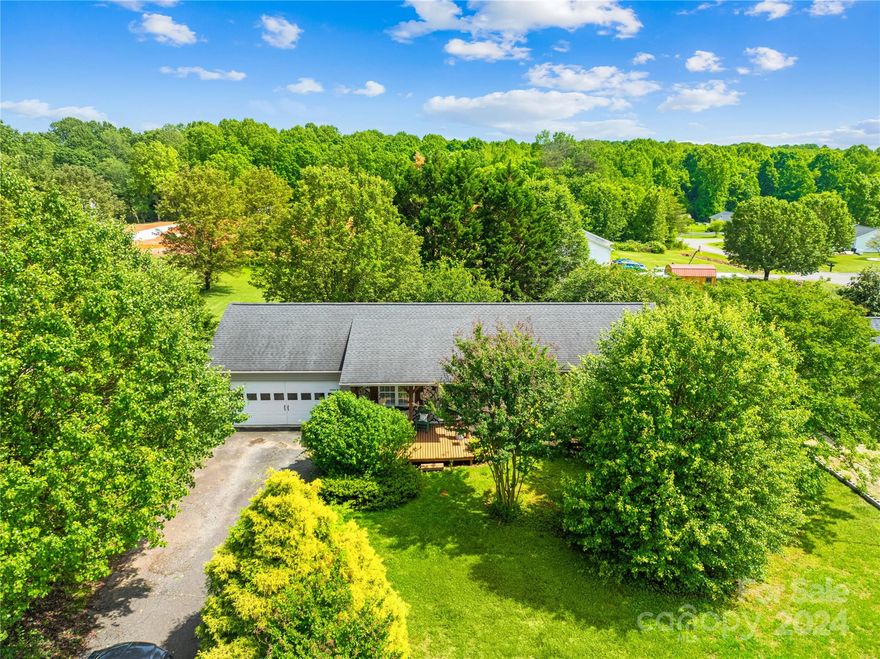 Cozy 3-bedroom 2 bath home sits on a flat, half-acre lot just inside Alexander County.  The welcoming open floor plan creates plenty of opportunity to cook your favorite meal while entertaining guests.  The one owner home gleams with special touches such as custom paint and stone backsplash.  Enjoy the quiet country setting and mature landscaping on the covered front porch.  With an updated HVAC, roof, and hot water heater this home is move in ready!  Storage building conveys.   Conveniently located only 15 minutes to the main shops in Statesville and 25 minutes to Hickory mall!  Seller will be relocating and is very excited to welcome the new homeowners!