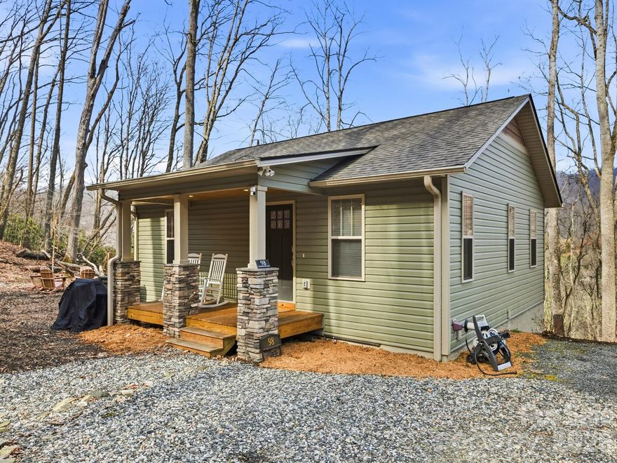 Nearly new 2023-built mountain retreat on 1.77 private acres just 2 miles from downtown Mars Hill, offering the ideal balance of comfort, efficiency, and lifestyle.  The main level features an open floorplan with durable luxury vinyl plank flooring, a gas fireplace, and a well-appointed kitchen with granite countertops, subway tile backsplash, stainless steel appliances, vented hood, and undermount workstation sink. Just off the dining area, a vaulted, fully screened porch with vaulted pine tongue-and-groove ceiling and ceiling fan creates a true outdoor living space with sweeping year-round mountain views, perfect for dining, relaxing, and entertaining in comfort. The primary suite includes a tiled walk-in shower with sunflower head, soft-close cabinetry, and a walk-in closet with built-in system. The lower level offers two additional bedrooms, a full bath, interior and exterior access, covered deck, and a bonus room already plumbed and wired for a future kitchen, ideal for guests, extended living, or potential rental use. Side-by-side laundry and utility room provide added functionality. Exterior features include a covered rocking chair front porch with stacked stone columns, pine tongue-and-groove ceiling, recessed lighting, gutter guards, low-maintenance vinyl siding, and a thoughtfully designed firepit area with Adirondack seating to enjoy the peaceful mountain setting. Positioned on a north-facing slope, this home stays naturally cooler in the summer, reducing cooling demand by approximately 10–20% while enhancing day-to-day comfort.  Property improvements include a French drain system along the rear of the home for proper water diversion and newly planted juniper ground cover for slope stabilization, along with established rhododendron. Located 2 miles near local favorites including Camden Coffeehouse, restaurants, brewery, and Mars Hill University, with easy access to Bailey Mountain Preserve (5 miles), Hatley Pointe Ski Resort and Zip N Slip tubing (6 miles), Appalachian Trail access at Big Bald (8 miles), and Laurel River recreation (10 miles). Just 15 minutes to Weaverville and 25 minutes to Asheville. Nearly new condition, flexible layout, low utility costs, and a private mountain setting make this an excellent option for full-time living, second home, or investment opportunity.
