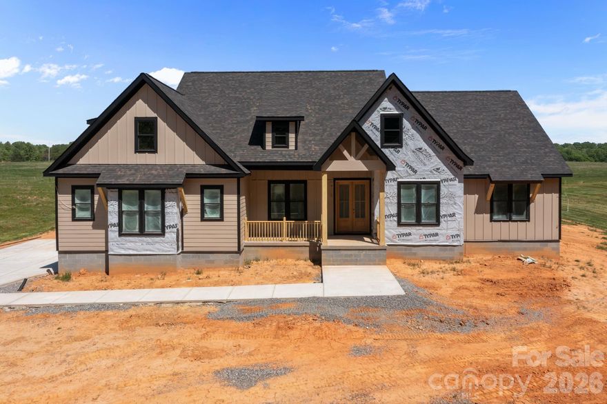 Luxury Custom Farmhouse Spec in Woodstone Communities newest subdivision, Woodstone Acres, with no HOA set to be completed 5/29/2026. This beautiful new construction is set on a huge 1.53-acre lot. The Cottonwood model is a sprawling 1-Story ranch offering approximately 2,980 sq ft with 4 bedrooms, office/study, all designed with upscale finishes and a thoughtful layout including 11’ ceilings in the main living areas. This model also includes a 16-speaker stereo system. The open chef’s kitchen features custom cabinetry, upgraded quartz countertops throughout, gourmet Forno gas range and appliances. This all opens to your living room area that features a gas fireplace and a 12’ sliding patio door leading to your huge covered porch with Trex decking allowing for indoor/outdoor entertainment. The primary suite offers a huge bedroom, spacious walk-in closet with custom built-ins and dresser drawers, and a spa-inspired bath with soaking tub and custom tile work. Additional highlights include beautiful engineered hardwood, tile and carpet flooring, custom wood shelving throughout, abundant storage, and unfinished upstairs bonus room with rough-in electrical, plumbing and HVAC ready for future addition. Exterior features Hardie siding with beautiful M-Rock stone and brick accents for lasting curb appeal and a sealed crawlspace foundation equipped with a dehumidifier. This is a great opportunity to get in early at the beautiful Woodstone Acres.