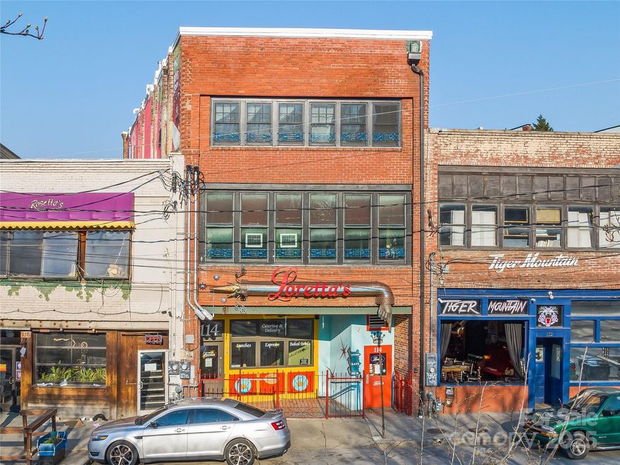 The historic & well-maintained Meadows Building is listed on the National Register of Historic Places. This property offers unparalleled exposure amidst the vibrant cityscape of Downtown Asheville. Well-positioned at the signalized intersection off I-240, this property offers interstate visibility and road frontage from 2 major city streets with high VPD. 7,042 SF with 3 floors of usable space. Layout is conducive to redevelopment or alternate uses, providing value-add income potential. Lower level includes a retail area and commercial kitchen infrastructure with dumbwaiter accessing all floors. Platform passenger lift services upper two levels. Wood flooring, high ceilings, natural light, and both east and west facing views of mountains and the cityscape. Building went through a full scale renovation in 2008. Recent upgrades include a new roof in 2021 and new windows in 2023. Paid parking (82 spots) directly across the street with additional street metered parking.