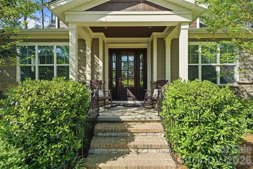 If you’ve been waiting for privacy, views, and convenience all in one—this is it. Located in desirable Riverchase Estates, this Craftsman-style home is surrounded by peaceful woods, offering stunning views from every level. Natural light pours in through expansive windows, highlighting beautiful details like tray ceilings, designer lighting, and custom built-ins. Enjoy the feeling of a secluded retreat while staying just minutes from Ballantyne, Indian Land, and major commuter routes. A dedicated office provides the ideal work-from-home space. The gourmet kitchen is a true standout, featuring top-of-the-line stainless steel appliances, a large center island, gas range, and a pantry with custom shelving and lighting, all seamlessly connected to a functional open floor plan ideal for everyday living and entertaining. The main-level primary suite provides comfort and privacy, creating a true retreat within the home. Stacking sliding doors open to a covered back porch with a fireplace and outdoor kitchen, creating exceptional indoor-outdoor living. An extended paver patio offers additional space to relax or entertain while enjoying the serene backdrop, and a backyard storage shed adds convenience. A fully finished 2-car garage features upgraded rubberized flooring for a clean, modern look. Residents of Riverchase Estates enjoy exceptional amenities including a gated entrance, clubhouse, outdoor pool, tennis courts and more. Ideally located, this home offers the perfect balance of tranquility and accessibility, just minutes from Ballantyne, Indian Land, and interstate access. Schedule a showing today!