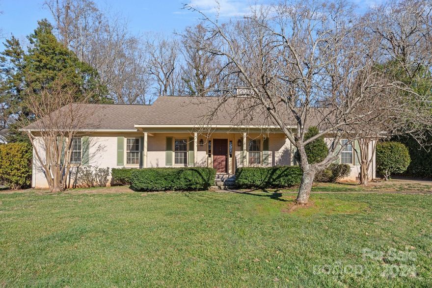 Great opportunity on a fabulous 1/2-acre, flat lot in the highly sought after Lansdowne neighborhood. This charming home has been lovingly maintained & boasts 3 bedrooms, 2 full baths & a 2-car attached garage w/ workshop area. The home features a cozy den w/ a wood burning fireplace (a wonderful room for conversation) and a lovely kitchen w/ natural cherry cabinetry & great counterspace. 3rd bedroom is currently used as an office. Side entry to mud room. Hardwood flooring throughout except baths. Patio & fenced backyard. The home has wonderful curb appeal w/ its rocking chair front porch but is in need of your personal touch - a great renovation/expansion opportunity! The home is situated on a beautiful interior street in the neighborhood and has easy access to shopping & dining, is a short drive to Uptown & very close to Providence Day School. Loads of renovations & new builds in the neighborhood. A pre-list inspection was completed & available upon request. Home is being sold As-Is.