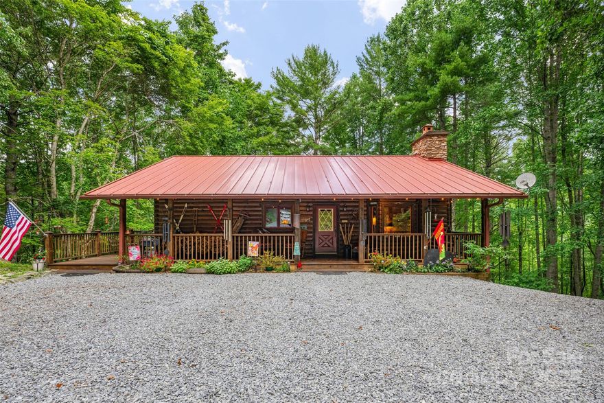 Discover this charming mountain cabin on 18.47 wooded acres in Sugar Grove, NC, just 20 minutes from downtown Boone! A large front porch welcomes you into an open-concept living, dining, and kitchen area with vaulted ceilings, a bay window, and wood-burning stone fireplace. Two bedrooms and 1.5 baths are on the main level, along with a side porch for grilling. The lower level offers a spacious family room with gas fireplace, third bedroom, full bath, laundry, and walk-out access. Recent updates: roof (2021), exterior staining (2020), HVAC (2023). Gravel driveway leads to ample parking and a firepit. Enjoy 90 feet of frontage on Laurel Creek—fish, wade, or relax to the sound of water. Multiple potential build sites offer expansion opportunity, including one with underground electric. A flat area along Laurel Creek Road offers room for a future structure or RV. Located just past "Trash Can Falls" and less than a mile from Watauga River access park. A peaceful retreat with space to grow!