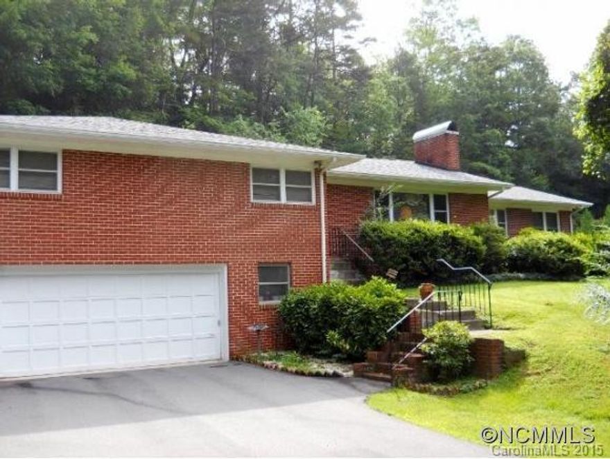 Attractive 3BR/2BA brick ranch on very tranquil & private .9 acre with gardens. Desireable just outside city limits on way to National Forest. Level access to back door via side path/driveway, wheelchair accessible. Sunny, spacious rooms. Shiny hardwood floors in many rooms, wood fireplace, a very welcoming home. Large Kitchen. Newer windows. Baths need updating. Easy one level living close to town without city taxes! Fall in love w the setting!