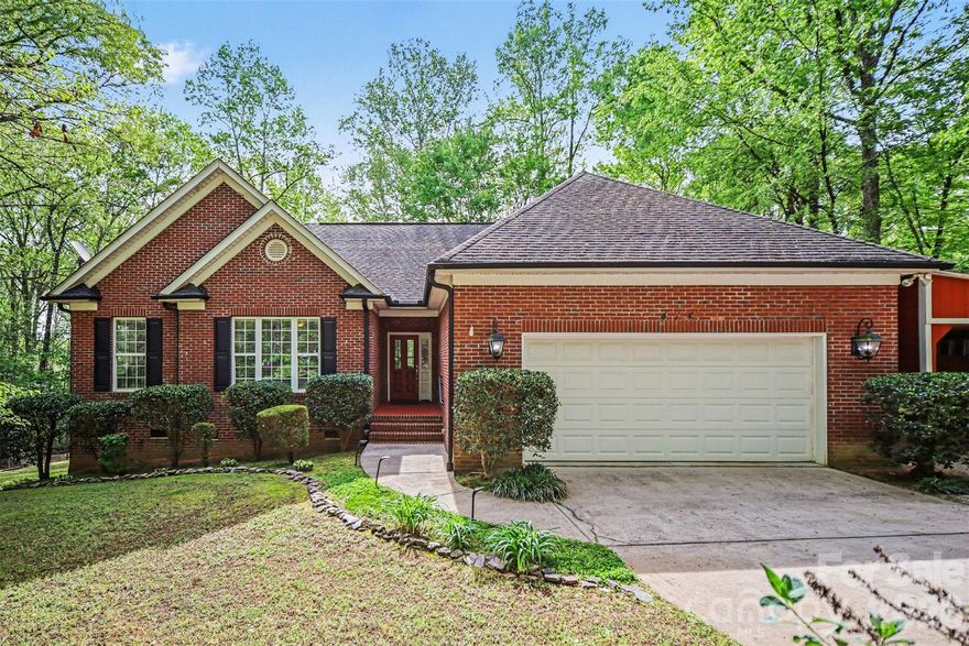 WATCH 3D TOUR! (if using Zillow go to facts and features - see more - virtual tour). 
If you’ve been searching for space, privacy, and a lifestyle that feels removed from the noise—but still close to everything—this is it.

Set on nearly 1 acre of beautifully wooded land in Waxhaw, this all-brick ranch offers a rare opportunity to enjoy peaceful, single-level living surrounded by nature, just minutes from the charm of downtown.

From the moment you pull in, the property invites you to slow down. Mature trees, flowering shrubs, and a quiet setting create a sense of peace that’s hard to find. Step inside and you’re welcomed by a warm, inviting interior with high ceilings, natural light, and thoughtful upgrades throughout, including granite countertops, tile backsplash, gas range (with electric option as well), and a spacious breakfast nook in the kitchen. The living room centers around a stone fireplace and a custom barn door crafted from 100-year-old reclaimed wood, adding character and history to the space.

The home has a split-bedroom floorplan that offers privacy while keeping the main living spaces open and inviting. A formal dining room and dedicated home office or sunroom provide flexibility for entertaining or working from home, while the primary suite offers a comfortable retreat with a walk-in closet and en-suite bath.

But the real magic happens outside.

The backyard is your own private escape—featuring a two-tier deck with pergola, fire pit area, and raised garden beds, all surrounded by nature. Whether you’re hosting friends, growing your own vegetables, or enjoying a quiet evening under the trees, this space was designed to be lived in and enjoyed.

With no HOA, a 2-car garage plus additional covered parking, and a location just minutes from Waxhaw’s shops, restaurants, and community events, this home offers the perfect balance of freedom, convenience, and lifestyle.