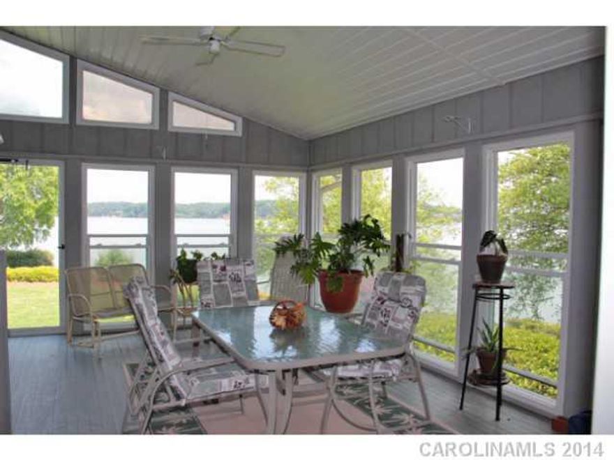 Your own private peninsula! Unique waterfront property with over 1000 feet shoreline stretching into the main channel of Lake Wylie. Two docks, boat ramp, and lakeside picnic shelter. 3BR ranch home, huge all-weather sunroom with incredible panoramic views.  Large dining room, great room with vaulted ceiling. Cedar storage closets in 2 bedrooms. Small room, bath & workroom in basement.  See tour!