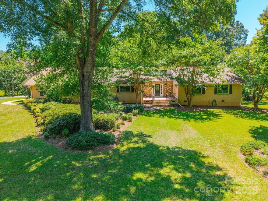 Welcome to desirable Quiet Acres neighborhood - convenient to schools, shopping, and downtown Rock Hill. This home sits on a large 1.3 acre flat lot with a fenced backyard and mature trees/landscaping. Enjoy the fresh updates like neutral paint, carpet, fixtures, and bathrooms. Updated kitchen includes tile flooring, kitchen island, stainless appliances, an abundance of cabinet space, granite countertops, tile backsplash, and new light fixtures. Spacious vaulted great room graced with beams and floor to ceiling stone fireplace. Owner's suite has dual walk-in closets, ensuite with dual vanities, tile flooring, multiple shower heads and sprayers in new shower as well. Tons of storage, walk up attic in garage and motorized lift to attic in home. Large front and back porches. New fans, fixtures, tubs/showers, toilets, and carpets make this home move-in ready.