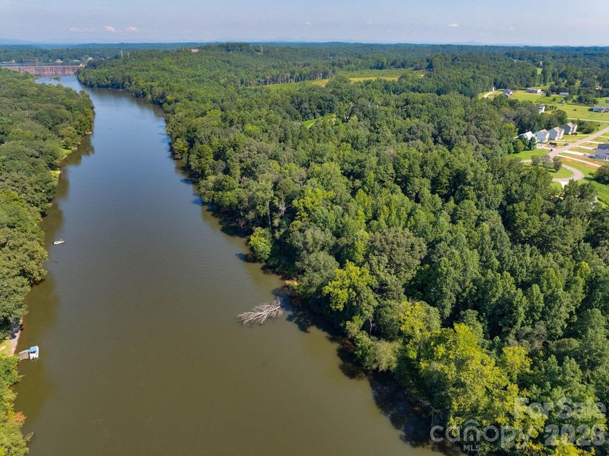 Enjoy waterfront living on this 1.30 acre lot on the Catawba River with 118' of shoreline for beautiful year long views! Private setting tucked away in a cul-de-sac in the gated River Rock community. Secluded yet close to everything with easy access to main highways and ideally placed between Statesville, Hickory, & Mooresville. Perfect getaway everyday for swimming, paddle boating, fishing and peaceful sunsets. River Rock has passed perc tests to guarantee all lots buildable when community was first developed. Bring your own builder or call today to get it touch with one!