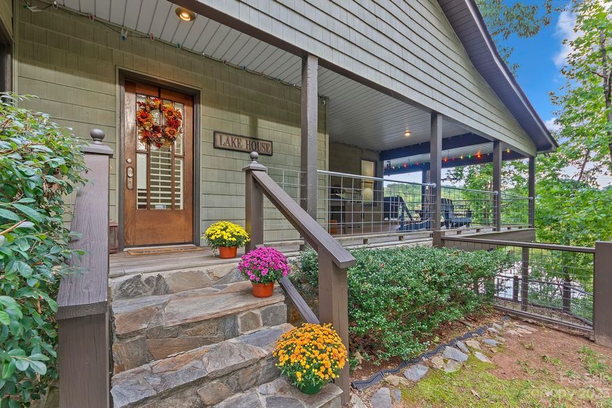 Absolutely stunning views from this 4bd, 3.5ba home on Lake Lanier. Incredible attention to detail from the architect owner including 8 pane custom floor to ceiling windows in the primary suite, plantation shutters, and stacked stone fireplace to the ceiling that flanks the vaulted great room and dining areas. Heart pine floors, transom windows and brand new tile in 2 bathrooms also enrich the true quality of this home. Kitchen features custom solid oak cabinets with tons of storage, 5-eye gas stove and 3 part sink. Lower level includes huge gathering room, extra bedroom, office, glass doors across the back facing the lake and beautiful flex rooms. Outdoor spaces include slate stairs, multi-level modern craftsman style decks overlooking the lake, and a circular drive for easy in and out and entertaining. Awesome boathouse right on the water with large attached dock and two parking spaces at the top! This property is also 4 parcels including a buildable wooded area - total of 1.3 acres!