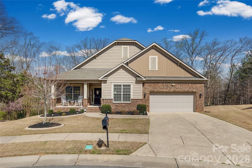 Welcome to this beautifully maintained 4-bedroom, 3-bath ranch home with a full walk-out basement, perfectly situated on an almost half-acre cul-de-sac lot backing to mature trees for exceptional privacy. Designed for both everyday living and entertaining, the home features an open layout with extensive hardwood flooring, crown molding throughout. The foyer leads to the formal dining room that flows seamlessly into the family room and gourmet kitchen, complete with granite countertops, an island, soft-close cabinetry with pull-out drawers, large pantry and a range with double ovens - perfect for hosting family and friends. The primary suite on the main level is privately tucked away, offering a spa-like retreat with a soaking tub, separate shower, double sinks, and an oversized walk-in closet. Both the primary bedroom and breakfast nook open directly to an expansive deck with a hot tub, creating the perfect place to relax while overlooking the peaceful, tree-lined backyard. The fully finished walk-out basement expands the living space with two additional bedrooms, a full bath, a spacious second living area with a 2nd gas fireplace, a private office, and a wet bar with beverage fridge—plus ample space for a pool table or game area. A 2nd kitchen could easily be added to this space, allowing for multi-generational living! A convenient storage room adds even more functionality. Outdoor living is just as impressive, featuring an expansive lower-level stone paver patio, koi pond with waterfall, and beautifully landscaped backyard. The under-deck drainage system keeps the patio dry during rain, allowing you to enjoy the space year-round. Additional highlights include central vacuum system with a garage connection for easy car cleaning, extensive hanging shelving in garage, and  a whole-house water filtration system. Energy efficiency is another standout feature, with solar panels installed in 2021 that help keep electric bills negligible. COUNTY TAXES ONLY, so the savings continue! This beauty offers easy access to both Fort Mill/Tega Cay and Steele Creek shopping, interstates, Lake Wylie, and Charlotte Douglas Airport.