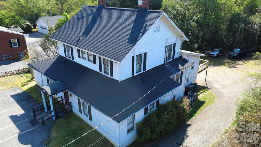 Located just minutes from I-77 and I-40, this prime spot is within walking distance to downtown Statesville, pickleball courts, shopping, restaurants, businesses, and more. The property offers approximately 3,000 heated sq ft plus roughly 500 sq ft of finished but unheated space, making it incredibly versatile for retail, office, personal residence, or other uses.  Inside, you’ll find 3-5 spacious offices or if used for residential purposes, 3 bedrooms, two kitchens, and 1.5 baths on the main level, along with 4 bedrooms/offices and a half bath upstairs.  A separate apartment/Airbnb adds strong income potential in this high-demand area, with its own alarm code and heat/air system, separate from the office space. HVAC systems and roof are approximately 2 years old. Parking is plentiful with spaces in the back and paved spots out front. Some exterior TLC is needed, and the price reflects that. This property would make a great residential home, with income potential from the attached apartment! Currently used as a business and Zoned 0-1.