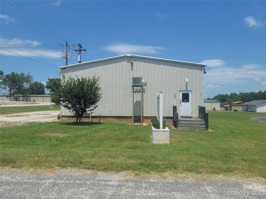 If you are looking for warehouse space with some office space in the Clover area just off of Highway 321 then this may be the property for you! If warehouse space is not what you need, then there are other potential uses in the B-2 zoning district that may suit your needs. This is a metal building that has 1 one loading dock and the outer walls are are approximately 16 foot tall on the sides with the peak of the building being approximately 20 feet.  The warehouse space has central air and gas space heater.  The office area has central heating and cooling also. Approximately 2661 square feet in the warehouse area and approximately 539 square feet in the office area. There are also two bathrooms and some light storage above the office area.