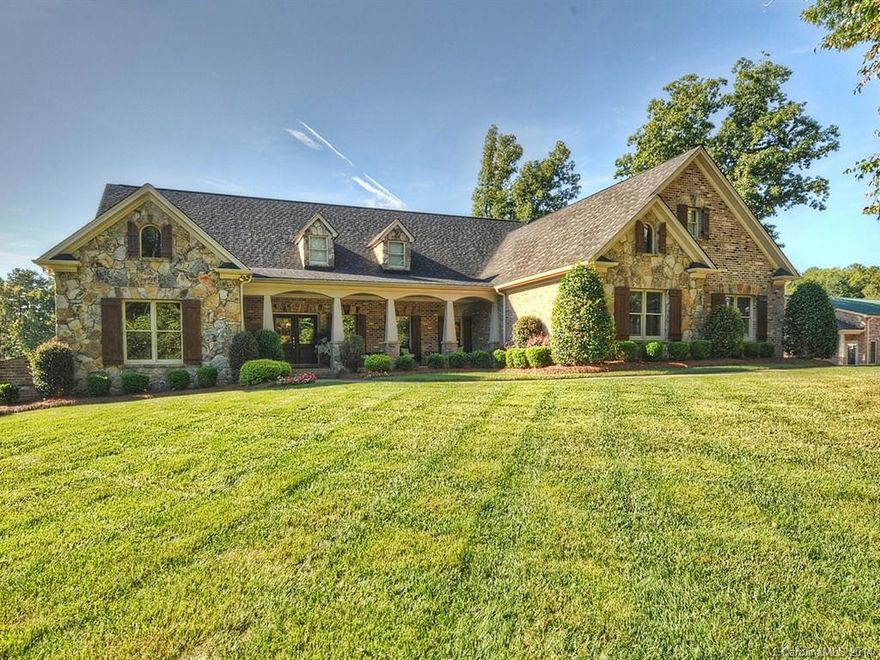 Immaculate & Enormous space in this sensational open floorplan! 22x18 GR w/ stone FP is big enough for grand living.  Chef's choice kitchen w/ island, granite, & lg pantry, HUGE DR! Gleaming wood & tile flrs throughout. BR 4 has full pine walls and ceiling and is currently used as office. Custom owners suite is amazing w/stone accents on bedside wall! Over 2000' floored walk-in attic plumbed and ready to be finished. 3000'+ in basement with "canning" kitchen & FP. 40x60 det gar/shop w/office!