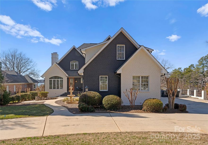 Newly renovated Lakefront retreat offering breathtaking panoramic views of Lake Norman! This expansive 5,331 sqft home boasts a private 1,000 sqft dock, 3-car garage, and approx. 160 ft of shoreline. Renovations include fresh paint, all updated bathrooms, stained dock and composite decking, re-stained hardwood floors, putting green, main level HVAC replaced in 2023, painted brick, new gutters and downspouts, and brand new kitchen. The bright kitchen showcases an oversized quartz island, high-end appliances, and new solid wood cabinetry. A finished walkout basement features a second full kitchen with a Viking commercial stove and pub seating. An elevator ensures easy access to all three levels. Enjoy 3 primary bedrooms with ensuite bathrooms, 2 laundry rooms, and 4 fireplaces. Expansive rear patio, 2 level dock, jet-ski dock, fire pit, and putting green, all overlooking main channel views. All appliances convey, and can be sold furnished, offering a turnkey lakefront lifestyle!