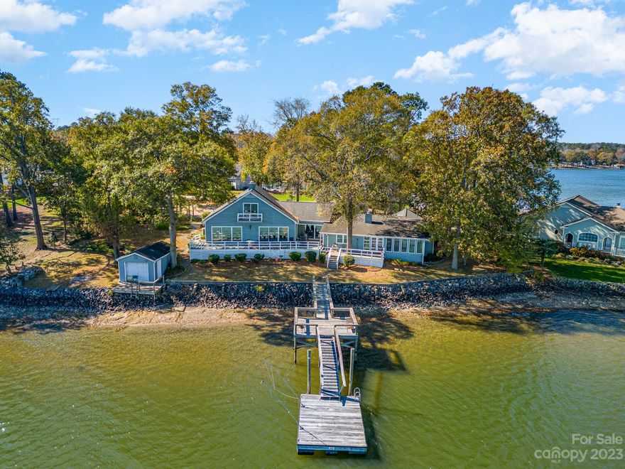 BACK ON MARKET - Buyer Financing fell through at no fault of the seller! Seller to offer SUBSTANTIAL CREDIT to the buyer. Experience lakefront luxury in this stunning 4 bedroom 3.5 bath haven on Lake Wylie. This property is located on the point of a peninsula just a few minutes from the South Sandbar and Ebenezer Park. Revel in panoramic lake views from all of the main living areas as well as the primary bedroom. Updated kitchen with Stainless Steel appliances and granite countertops.  Beautiful wood floors throughout. The fourth bedroom has a full bathroom connected to it. Please note that the closet for this bedroom is outside the bedroom door. This can be used as a bedroom or office/media room. The property has two storage buildings and is complemented with almost 200 feet of prime lake frontage. Entertain on your expansive pier, dock and floating dock, creating memories against a backdrop of natural beauty. Sunrises and Sunsets are incredible! Your waterfront dream home awaits!