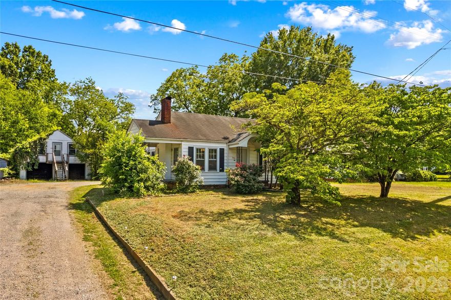 This 2 bed/1 bath bungalow with large outbuilding in fantastic location. Convenient to shopping, I-85, 73 & 29.  Lovely starter home or investment opportunity.  This home features a freshly painted interior and newer laminate floors throughout.  HVAC was replaced and updated to include central air in late 2023.  This home comes with a large outbuilding offers over 600sf of storage in total.