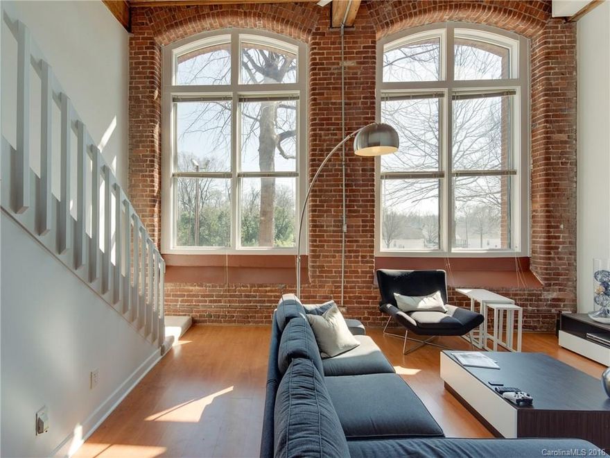 Amazing loft home in the Nationally registered historic Hoskin's Mill building.  This stunning 2 bedroom condo has an open floor plan and lots of natural light from the soaring two story living room windows.  The main floor bedroom would make a great guest room, office, work out room and more!  The secure entry building is minutes from Uptown, 77, 277 and the airport!  Highlights include a lofted bedroom, exposed brick walls, ample common space and an amazing location!  Call with any questions!