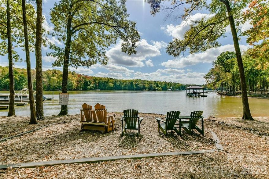 7018 Heron Rookery Way has it all: peaceful wooded views, a private fenced yard, and neighborhood access to Lake Wylie, plus a comfortable and bright interior with sleek finishes and abundant storage. The open concept main living area features 9' tall ceilings and tons of natural light. A wide archway frames the kitchen with a large island, granite countertops, stainless appliances, and a revamped pantry. The adjacent dining area provides ample seating and leads to the backyard oasis with a privacy fence and added paver patio. The main level bedroom makes a great office or flex space. Upstairs, the generous primary suite features an oversized shower, double vanity, and the closet of your dreams. The laundry room conveniently connects to both the primary closet and the common hallway. Two additional nicely-sized bedrooms, a full bathroom, and a large landing/loft complete the upper level. Ideally situated within the community, this townhome provides unbeatable peace and privacy. The Vineyards offers fantastic amenities like lake access, two pools, pickleball courts, and more. Welcome home!