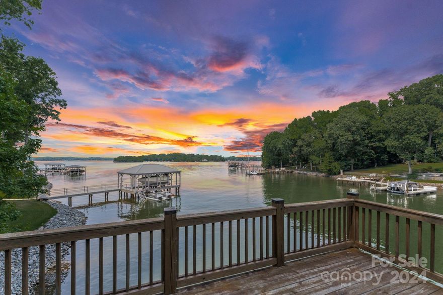 This stunning waterfront home on the coveted Brawley School Peninsula, just before The Point, offers long, serene views and is nestled on a private road surrounded by estate homes. Built on a generous .713-acre lot with approximately 138 feet of shoreline, the property boasts a private double-decker dock constructed in 2018/2019. The residence features three bedrooms and two bathrooms, with recent updates including porcelain tile that resembles wood, newer tankless hot water heater and heat pump was replaced. Located on a private paved street with NO HOA, this home is surrounded by multimillion-dollar properties, providing a luxurious and tranquil living environment. Per Soil Scientist a four bedroom septic seems feasible.