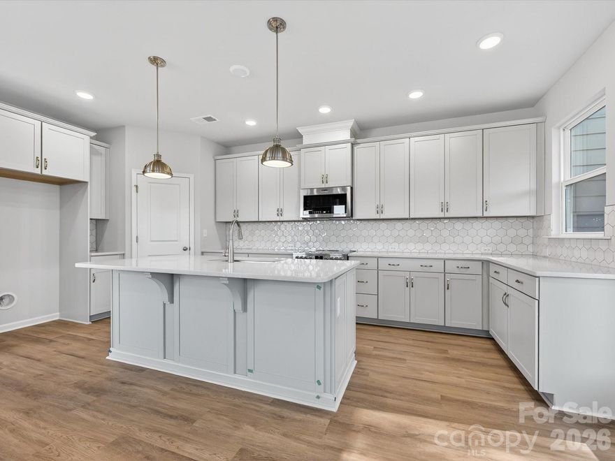 This beautifully crafted end-unit townhome offers a rare combination of natural light, private outdoor space, and luxurious comfort—all just minutes from the charm and character of historic Downtown Waxhaw. Oversized windows fill the home with natural light, offering scenic views of the private, wooded backyard—an uncommon feature in townhome living. The open layout is both functional and elegant, designed to accommodate everyday living as well as effortless entertaining. Bringing your furbaby?  You can fence in the backyard!The Owner’s Suite is a true retreat, complete with a private sitting room perfect for reading, relaxing, or creating your own quiet sanctuary. Additional highlights include an oversized two-car garage, providing generous space for vehicles, storage, and hobbies.As an end unit, this home enjoys added privacy, extra windows, and more outdoor space—all enhancing the quality of everyday living.