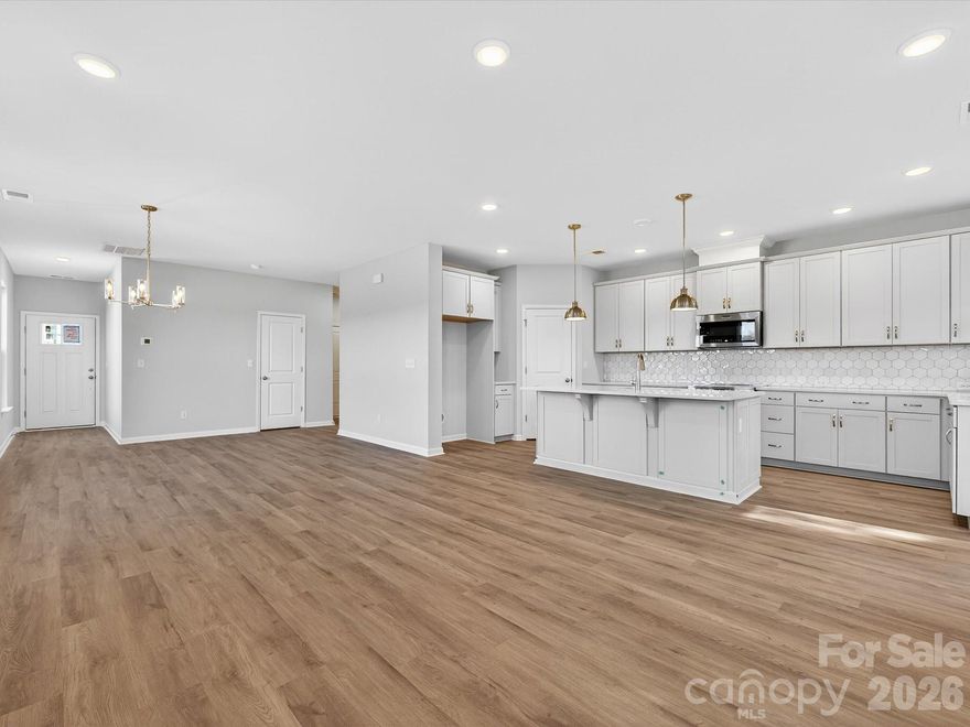 This beautifully crafted end-unit townhome offers a rare combination of natural light, private outdoor space, and luxurious comfort—all just minutes from the charm and character of historic Downtown Waxhaw. Oversized windows fill the home with natural light, offering scenic views of the private, wooded backyard—an uncommon feature in townhome living. The open layout is both functional and elegant, designed to accommodate everyday living as well as effortless entertaining. Bringing your furbaby?  You can fence in the backyard!The Owner’s Suite is a true retreat, complete with a private sitting room perfect for reading, relaxing, or creating your own quiet sanctuary. Additional highlights include an oversized two-car garage, providing generous space for vehicles, storage, and hobbies.As an end unit, this home enjoys added privacy, extra windows, and more outdoor space—all enhancing the quality of everyday living.