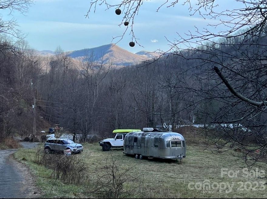 Here is the perfect opportunity for off grid living or investment! No restrictions, so the sky is the limit! Beautiful mountain views and dark starry nights! The calming sounds of nature all around you! Crisp spring water, with a stream, babbling thru the property. Inspiring, 1.08 acre, vacation getaway, conserving energy, saving money to help the environment! Plenty of sunshine for sustainable solar power. Has a nice garden area to grow your spring, summer and fall vegetables! Great for multiple tiny homes with short term rentals!! The Airstream conveys with property! There is a possibility to get the Airstream bonded. Property does not have a power easement. *UPDATE* There is now a nice storage building that conveys with property. It has been about 3/4 insulated and some flooring. The owner lived in it, off grid.