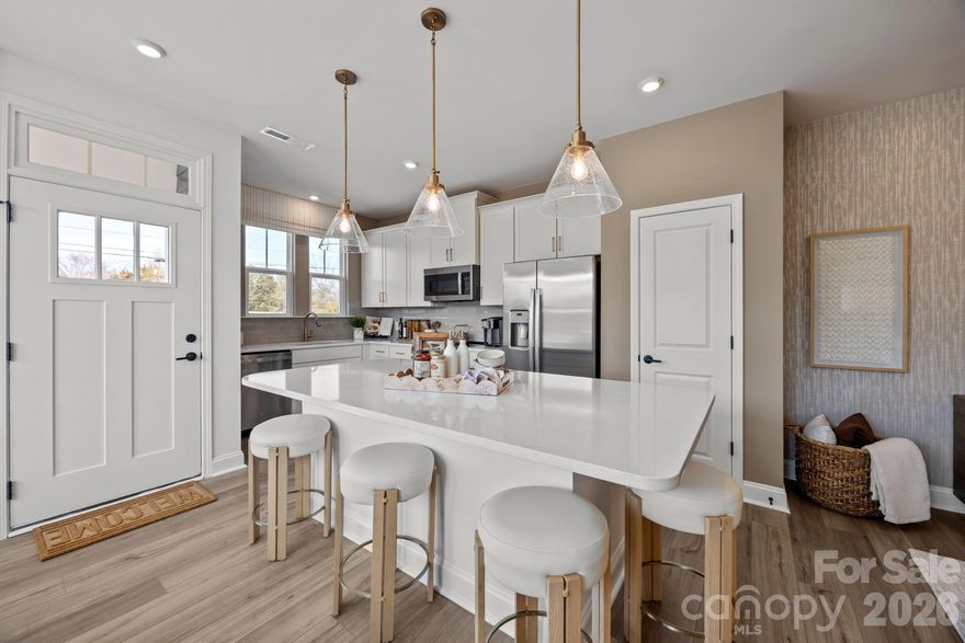 Welcome to Odell Park Premier Townhomes Offering the Most Convenient Access to Regional Commuter Routes and Concord Mills. Our Rochester plan features 3BR / 2.5BA  with a 1-car garage offering modern design and practical spaces just minutes to I-485 , Highland Creek, and Concord Mills Blvd. The main level features an open-concept layout with luxury vinyl plank flooring. The kitchen includes quartz countertops, stainless steel appliances, a spacious island, and an approximately 12' deep finished storage closet—ideal for pantry or utility use. A bright dining area and connected family room make the space inviting for both daily living and entertaining. Upstairs, the Rochester plan offers three bedrooms, two full baths, and a convenient laundry closet. The primary bedroom and bathroom highlight a 5' tiled shower, dual vanities, and a large walk-in closet. Secondary bedrooms provide flexibility for work-from-home, guests, or hobbies. Odell Park offers quick access to  shopping, dining, parks, major highways, UNC Charlotte, and local employment centers. HOA services cover water, trash removal, lawn care, and landscaping, supporting a low-maintenance lifestyle in a convenient Charlotte location. This home is under construction and scheduled to be completed by the end of March/ Beginning of April 2026 giving buyers the opportunity to plan ahead and secure new construction at today’s pricing.