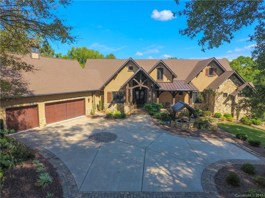 This home offers privacy and the highest quality workmanship. Tucked away on 15 beautiful, wooded acres, just 15 minutes south of Ballantyne, this spectacular 5 BR, 5824 sq ft “Montana Lodge” home features rich woods, travertine, custom-built cabinetry, custom ironwork, casement windows, hand-crafted millwork, and solid core 8 ft interior doors, as well as 4 fireplaces, an equestrian trail through 8 wooded acres, fenced pastures, barn, and 2nd living quarters. Built 2010 by Everett Custom Homes.