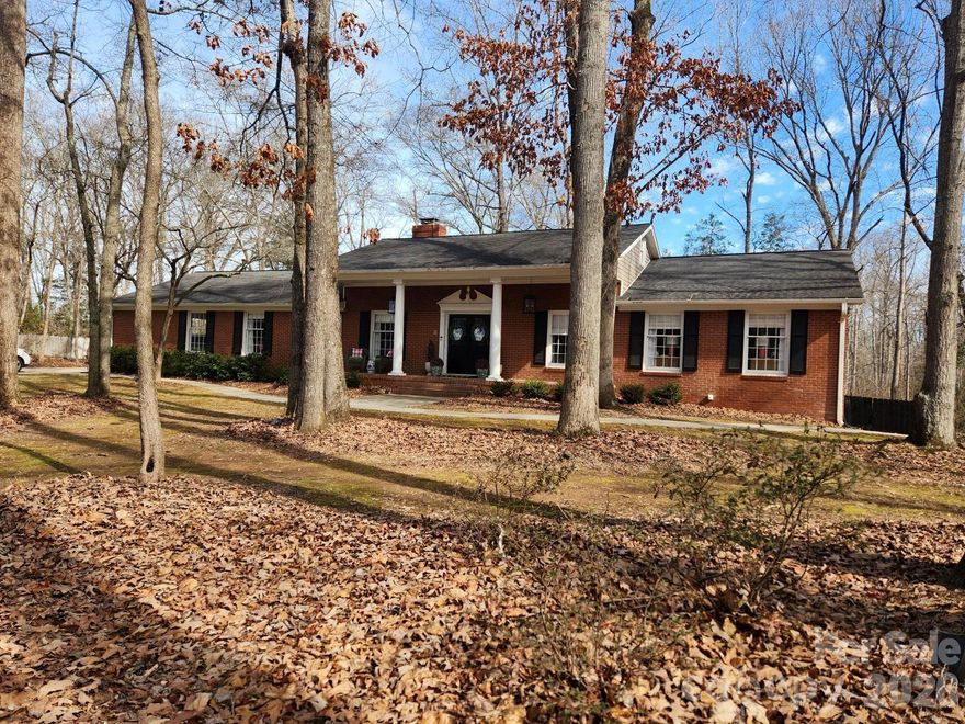 Located in an established neighborhood, this timeless jewel all-brick home offers over 3,500 square feet of beautifully designed living space on a spacious .77-acre lot. With 3 bedrooms on and 2.5 bathrooms and the 4th bedroom up, this home blends classic charm with room to spread out.

The main level features a formal living room and formal dining room ideal for entertaining, along with a warm and inviting family room with fireplace. The galley kitchen shines with quartz countertops and efficient layout for everyday living.

The fully finished basement adds incredible versatility, complete with a wood-burning fireplace and walk-out access — perfect for a recreation room, home office, gym, or guest space.

Step outside to a large rear deck overlooking a fully privacy-fenced backyard, ideal for gatherings, pets, or play. A charming storage shed provides extra space for tools and hobbies. The carport also includes additional storage for added convenience.

With solid brick construction, generous living areas, and fantastic indoor-outdoor flow, this home offers space, character, and functionality in one beautiful package.