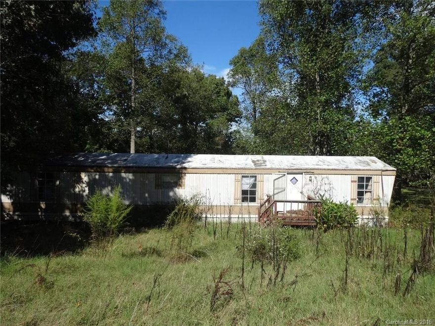 Bargain price for a gently sloping half acres lot with trees and an ailing home is close to the Statesville airport and has quick access to I-40. The  singlewide home has minimal value needs substantial repair or replacement. Close to Lakewood Golf Course. Iredell County has a septic record.