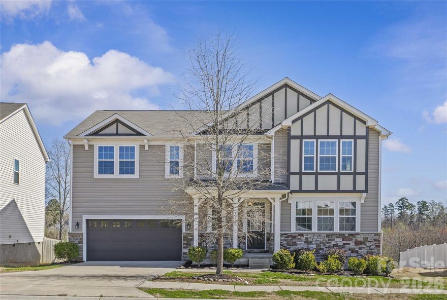 YOU HAVE ARRIVED!!! Beautifully designed 5 bed, 3.5 bath house offers open floorplan with flex spaces that adapt for your everchanging needs. Main level features seamless great room and kitchen combo enhanced by cozy fireplace—perfect for gathering and entertaining. Just off living area, step onto the deck overlooking a private backyard with wooded common area behind and generous space between homes for added privacy.  Not to be missed is highly desirable main-level bedroom with its own ensuite bath (ideal for guests or multi-generational living, or office space, or...) plus convenient half bath for visitors.  Generous flex space can be dining room, playroom, office, or whatever you decide. Upstairs, you’ll find spacious loft, three secondary bedrooms, full bath with double sinks, and centrally located laundry room. Primary suite (with generous closet) provides a relaxing retreat with ensuite bath, perfect area to unwind after busy day.  Enjoy neighborhood amenities including pool and playground, all while being minutes from major highways, shopping, dining, and everything Charlotte has to offer.  This one truly checks all boxes- space, privacy, awesome location.