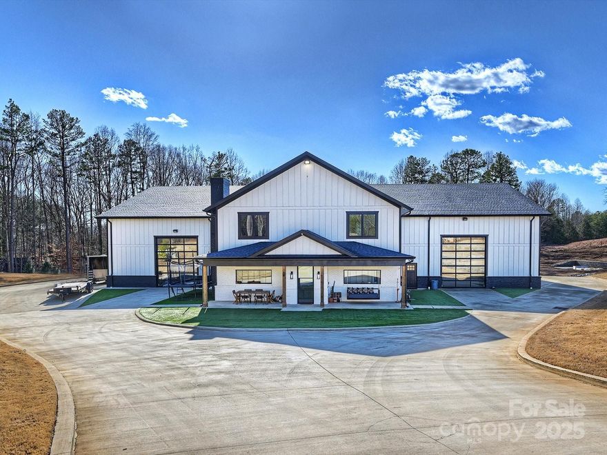 Experience the pinnacle of privacy and adventure in this nearly 15,000 sq ft custom barndominium estate, set on 35 pristine acres. Thoughtfully designed for automotive collectors, off-roading enthusiasts, and those seeking space to live boldly, the residence features two fully independent living quarters—each with its own kitchen and living area—and 4 generous bedrooms, perfect for guests or multi-generational living. Enjoy the convenience of private fuel storage, underground garages, and a secure gated entrance. Outdoors, unwind beside the resort-style saltwater pool framed by elegant turf. Host unforgettable gatherings in your private bar and club, or embrace your adventurous side with a rock climbing wall, basketball court, and expansive off-road terrain.This estate offers unparalleled luxury and freedom—where adventure meets elegance, and your dreams become reality.