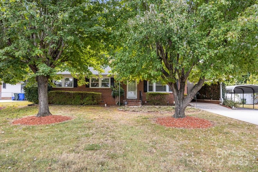 Charming 3 bedroom, 1.5 bath home with a covered back patio, perfect for outdoor relaxation.  Features an attached carport and a detached carport for ample parking.  Includes two buildings and a fenced-in backyard with beautiful giant trees, offering privacy and shade.  Conveniently located just minutes from the interstate and Cherry Park.  Ideal for comfortable living.