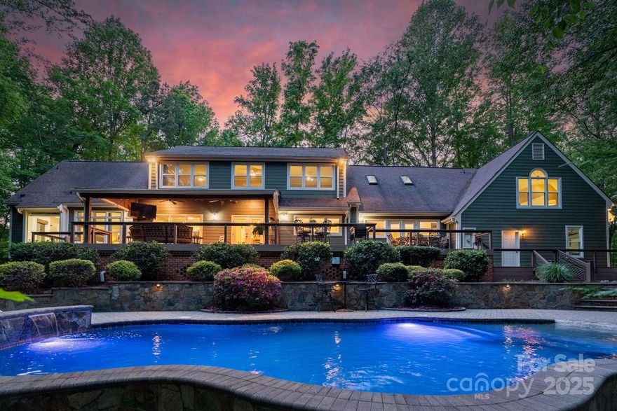 Nestled on 4.22 private wooded acres, this stunning 4BR Marvin home blends luxury and function. The renovated chef’s kitchen features a massive island, barn-door pantry, 36" Jenn Air range, farmhouse sink, & pro appliances. The family room with brick fireplace opens to a 1000+ sf deck w/ covered area  & landscape lighting. Main-level primary suite with renovated bath featuring heated tile floors, freestanding tub, walk-in shower, and custom closet. Upstairs includes 2nd primary suite, 2 additional BRs, 2 updated baths, bonus room w/ kitchenette, ½ BA, & walk-in attic. 2011 exterior reno (roof, windows, siding, gutters/guards), 2021-22 interior remodel (kitchen, 3.5 BAs, & floors), 2025 pool replaster & new decking. Enjoy the outdoor oasis, featuring a fire pit, fenced yard, pro landscape lighting & lush foliage. 3-car garage, detached 2-level workshop & oversized storage shed! Expansive entertaining areas & plenty of space for outdoor activities, play, & relaxation!