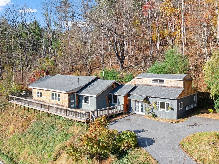 Welcome to your dream home! Nestled on 1.65 unrestricted acres with stunning mountain & creek views, this updated 4BR/3BA home blends comfort, flexibility & style. Enjoy 2,547 sq ft of well-designed space with a main-level primary suite featuring a luxurious ensuite bath & walk-in closet. The open kitchen shines with white cabinetry, center island, quartz countertops & stainless appliances. A dedicated studio space adds room for creative work or hobbies, while the full-length Trex deck and 6-person hot tub offers the ability to unwind in an ultimate outdoor setting. Recent upgrades include a new tub, new hot water heater, electric heaters & thermostats, well pump, gutters, smart locks on exterior doors & French drain n the rear for your peace of mind. Whether you’re looking for a turnkey short-term rental with a proven track record or the perfect family home, this property delivers on every front—with no restrictions to limit your vision. Don’t miss your chance to own this haven!