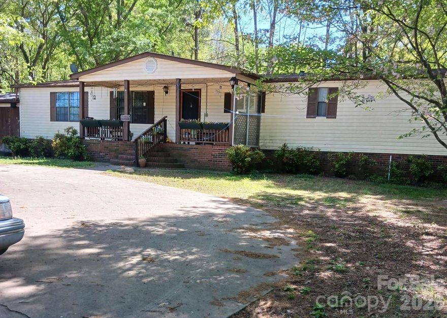 This is a charming, country, ranch style home on dead end st loc between Asheville, Charlotte & Spartanburg. It has an open flr plan. This is solid mfd home with front & back covered porches. Has handi-cap access from rear porch to garage. The yard is fenced except front. It has a pond with a fountain feature & colored lights at night. The property has 6 outside water spigots. There are newer mini split heating/AC units. New vinyl wood-looking planks in kit & master bdrm. New kit countertops and new frig negotiable based on offer. Real wood V-Joint on the walls created by homeowner in main living area. Large master bdrm has HUGE walk-in closet, HUGE bath with 8' counter with his & her sinks, new cabs. The master bath has walk-in shower & HUGE closet. There is a two car carport that has been enclosed with a workshop on one side. If your looking for storage this home has it. AI has been used on some pics showing space without furniture. Selling AS IS!