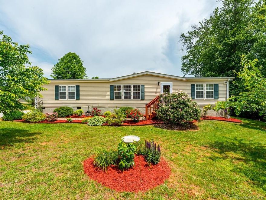 Discover this lovely & renovated home in Candler with remarkable detail and attention to style! Inviting and welcoming, you will appreciate the openness and brightness as soon as you step inside. Imagine enjoying your evenings by the fire or hosting a cookout out on the large back deck and yard. Lots of room for family, friends and storage. Outside is surrounded by beautiful landscaping, long range views, and the pleasant community. Only a 20 minute drive to Asheville, come see it today.