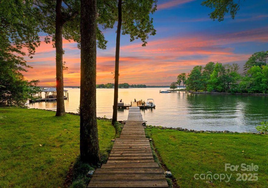 Prepare to be captivated by the breathtaking panoramic waterviews. This charming home offers the best of both worlds with a swim-friendly cove and magnificent long-range sunset views. Located on the coveted Brawley School Peninsula, this property has no HOA. Rebuilt from the studs in 2003 and refreshed with new interior paint in Decmeber 24', the home features an open floorplan with a grand two-story great room. Enjoy the architectural beauty of cathedral ceilings and floor-to-ceiling windows that showcase expansive waterviews. Every room in this home boasts a stunning lake view. The lower level walk-out basement includes 2 additional bedrooms, a family room, and a full bath. The property also features a spacious 2-car detached garage with a large walk-up storage room, plus an additional 1-car detached garage/workshop. This versatile property is ideal as a family home or vacation property. Embrace the vacation lifestyle every day in this exceptional Lake Norman home!