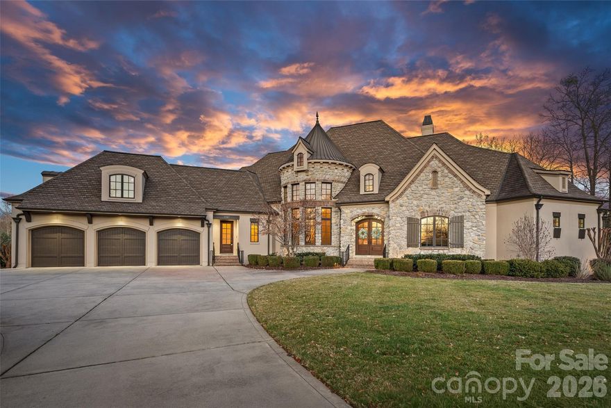 Situated on a grand corner lot in the exclusive gated community of Challis Farm, this sophisticated estate offers refined living and exceptional entertaining just minutes from SouthPark. A private golf cart path provides direct access to Carmel Country Club, while residents also enjoy private lake access and a community dock.
Inside, beautifully refinished walnut floors, soaring ceilings, and elegant architectural details create a timeless and inviting atmosphere. Expansive windows throughout the home provide panoramic interior views overlooking the outdoor living spaces, creating a seamless connection between indoor and outdoor entertaining.
The showstopping chef’s kitchen features a double island, quartzite countertops, custom hood, 8-burner Wolf range, Sub-Zero refrigerator, sizable scullery, and a sunny breakfast area overlooking the veranda. A screened porch off the kitchen offers a peaceful setting for morning coffee.
The main level also includes a private executive office, living room with built-ins and a gas fireplace with a striking limestone mantel, a sophisticated formal dining room, and a custom wine bar. The primary suite on the main level features vaulted ceilings with exposed wood beams, custom his and hers closets, and a spa-style bath with a tiled walk-in shower, soaking tub, and individual vanities.
Upstairs are three bedrooms, each with its own en-suite bath, along with a spacious bonus room and versatile loft space perfect for studying or reading a book.
The fully finished basement is designed for elevated entertaining and extended living, featuring a custom 450-bottle wine room, billiard area, full living room with gas fireplace, second kitchen, flex room or gym, bedroom and full bath, as well as a golf cart garage. This level opens directly to the covered patio and outdoor kitchen, creating an ideal flow for hosting and outdoor gatherings while also offering tremendous storage throughout.
This is a rare opportunity for elegant estate living in one of South Charlotte’s most sought-after gated communities.