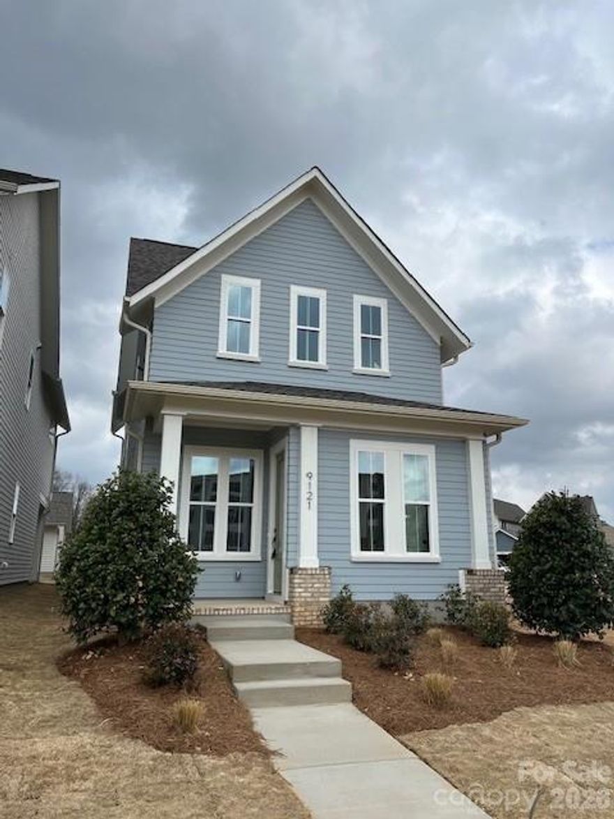 NEW CONSTRUCTION in East Charlotte -This gorgeous home features front columns on brick pillars. Open design w/10' ceilings & 8' doors/cased openings on first floor. Standard Modern design package, undercabinet lighting, quartz counter tops, & center island. Walk-in pantry. Electric fireplace with judges paneling detail and floating shelves on either side. Luxury vinyl plank flooring on main level. Drop Zone w/stained seat, upper shelf, brackets & hooks. Primary bedroom on main level w/LVP flooring, full bath, double vanity, tiled shower with frameless glass shower enclosure & huge walk-in closet. Cabinets in laundry room above w/d area. Open stair rails w/oak treads. 9' ceilings on upper level with 4th bedroom/full bath guest suite in lieu of bonus, 2 guest bedrooms w/walk-in closets. Tub/shower combo in hall bath w/ceramic tile walls & flooring. Ring doorbell & camera w/Yale door lock. Covered rear porch & 2-car detached garage. Front lawn maintenance & irrigation covered by HOA.