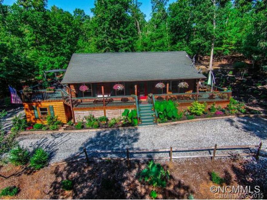 Come home to this totally renovated log cabin, replete with style and color. New kitchen featuring SS appliances, granite, and eye-popping cabinetry. Hickory floors throughout. New bathrooms with tile and skylights. Multiple decks and hot tub ensure easy entertaining and relaxation. Area below large deck with concrete slab is enclosed and could be finished. Private and serene. Less than 10 minutes to TIEC! SELLER WILL DO A LEASEBACK!