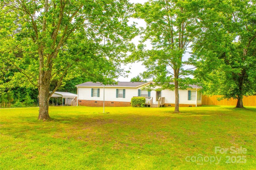 BACK ON THE MARKET WITH A NEW PRICE!! Charming 3 Bed, 2 Bath Home on 1.76 Acres – York, SC
Escape to peaceful country living with this well-maintained 3-bedroom, 2-bath doublewide home offering 1,740 square feet of comfortable space. Situated on a generous 1.76-acre lot, this property combines privacy, open space, and convenient access to downtown York.
Step inside to an open floor plan featuring a spacious living area, a dedicated dining space, and a functional kitchen with ample cabinet storage and a center island—perfect for daily living or entertaining guests. The split-bedroom layout offers added privacy, with a large primary suite that boasts a walk-in closet and a private bath complete with a soaking tub and separate shower.
Out back, you'll find a fully fenced-in backyard with a privacy fence—ideal for pets, kids, or simply enjoying your own quiet retreat. Solar panels installed in 2018, new roof and gutters. Storage building and carport