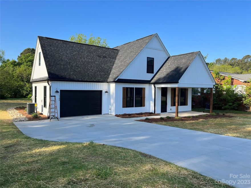 NEW CONSTRUCTION, as close to custom construction you can get without the hassle of building!  Convenient to downtown Albemarle, NE Connector, Hwy 24/27. 52 and 73.  ZERO steps to entry - Covered Front and Rear Porch, extended driveway pad for additional parking, Direct Drive Garage Door Opener, 8ft front door with keyless entry opens into expansive living room and dining room.  LVP flooring on Main Level.  Kitchen features Quartz Counter Tops with Tile Backsplash, Built in Wood Shelving in Closets and Pantry (barn door).  Extended cabinets to the ceiling with soft close hardware. Contrasting Kitchen Island.  Pendant lighting in kitchen with additional recessed Lighting throughout the house. Ceiling fans in the Living Room and Bedrooms.  Spacious Primary Bedroom with Walk-in Closet and Large Bath featuring dual sink vanity and oversized shower.  Upstairs landing has an office/computer niche.  Level lot/yard.