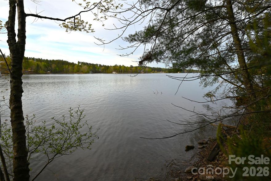 Discover a premier waterfront lot offering over 500 feet of shoreline on Lake Rhodhiss, with the potential for a private dock ( pending approval). This exceptional property invites you to embrace the ultimate lake lifestyle within a private, gated community nestled at the base of the Blue Ridge Mountains- where tranquility and scenic beauty meet. Enjoy breathtaking long-range North and North East Views of the Main Channel, providing a stunning backdrop for your future dream home. Tucked away at the end of a cul-de-sac, the lot ensures added privacy with no through traffic. In addition to the community's shared ammenities, this lot offers the unique opportunity to build your own private dock directly from your property ( pending approval ), making lake access both convenient and exclusive! Community amenities are designed for both comfort and recreation, including city water, underground utilities, cable and high-speed internet. Residents also have access to RV and Boat Storage, a Covered Pavilion, Fire Pit and Grilling Areas, Kayak and Paddleboard Launch Sites and Community Boat Slips. The property successfully passed a perk test in 2021 for a four-bedroom home, offering added confidence as you plan your build. The current owner has house plans if desired. This is a rare opportunity to build your custom lakefront retreat in a peaceful yet amenity-rich setting.