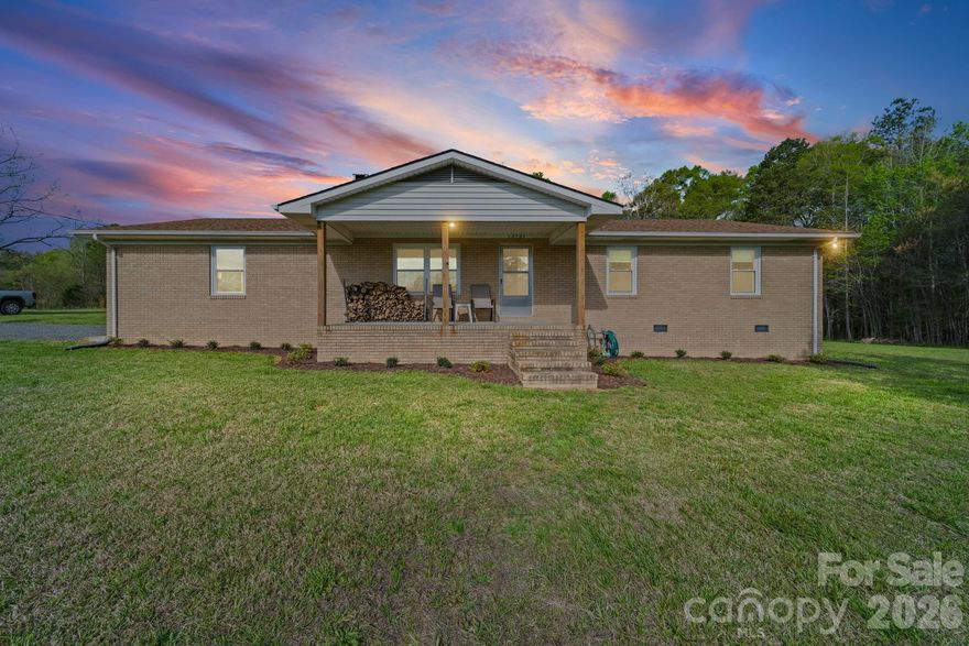 Updated home on 18.97 acres in South Stanly Area - just outside of the Aquadale area.  Brick ranch sits a distance from the road with a winding gravel driveway.  Cleared area is mostly flat with a sloped wooded area leading down to a creek that boarders the rear property line (see survey).  Covered front porch and rear screened porch provide great places to meet guests or entertain and relax and take it all of nature.  Conversation area - arbor beside repurposed chimney from old farmhouse that once stood in that location provides the perfect setting to build an outdoor fire on cool evenings.  Home features large open floor plan with combined living, dining and kitchen areas. Living room features a wood burning fireplace. Kitchen features stainless appliances, granite counter tops and shiplap siding.  Expansive utility/laundry room provides space for projects, storage, and pantry closets.  Updated bathrooms with new fixtures and vanities.