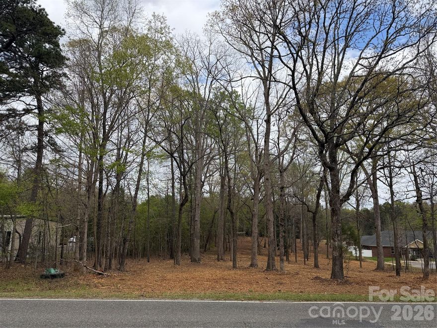 Wooded level lot across from Hospice, with convenient access to NC18 and US74 By-pass. Parcel is currently split zoned, but we can assist the buyer in rezoning to fit your development plans.